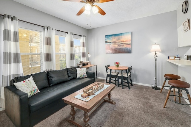 carpeted living room featuring ceiling fan and a textured ceiling