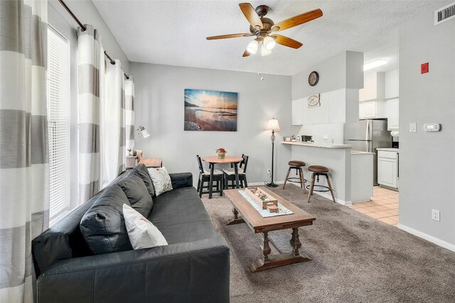 3404 American Dr Unit 1226, Lago Vista, TX 78645 - living room with ceiling fan, light carpet, baseboards, and a textured ceiling