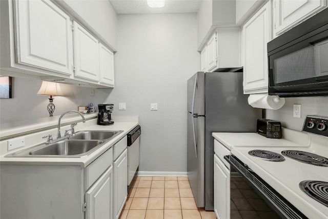 kitchen featuring white appliances, light tile patterned flooring, sink, and white cabinets