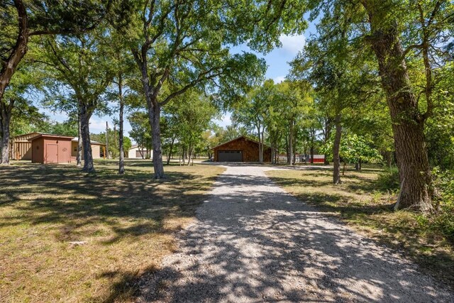 view of front of home with a garage and an outdoor structure