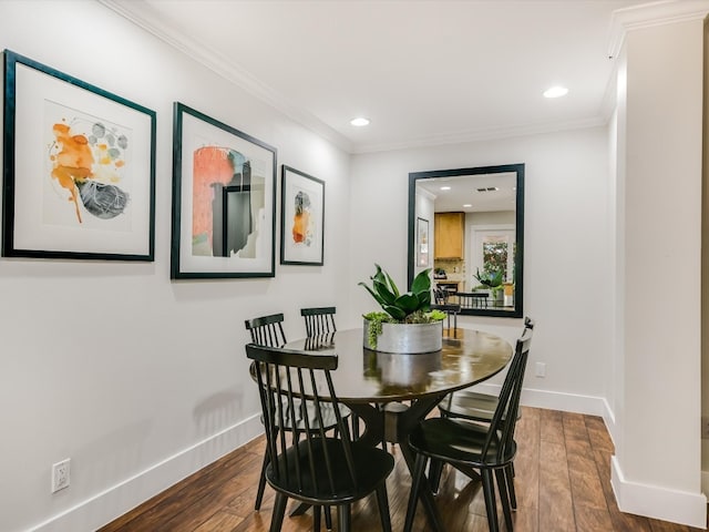 dining space featuring crown molding and dark hardwood / wood-style flooring