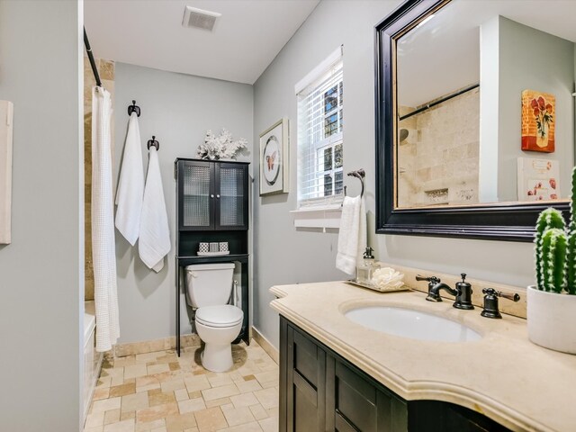 full bathroom with vanity, toilet, and shower / tub combo with curtain