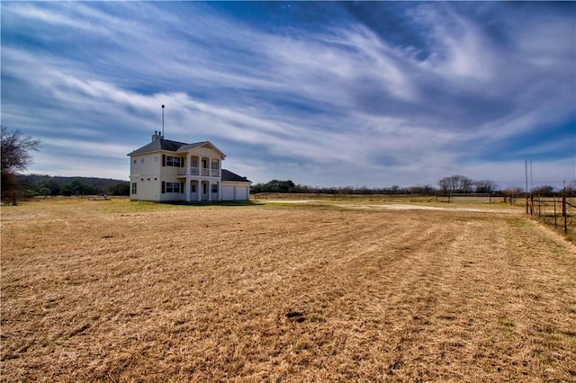 view of yard with a rural view