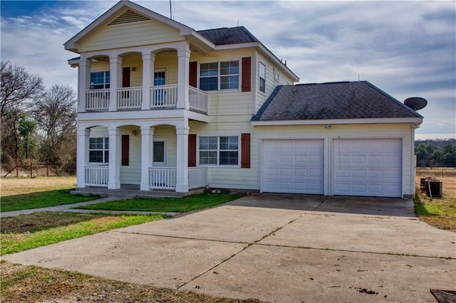 view of front of home with a balcony, a front yard, a porch, and a garage