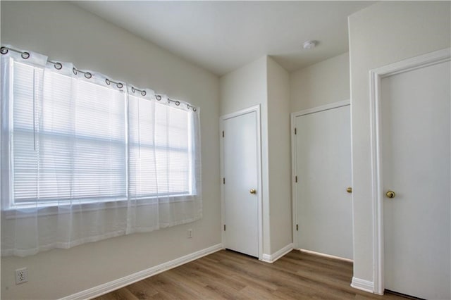 unfurnished bedroom featuring a closet and hardwood / wood-style floors