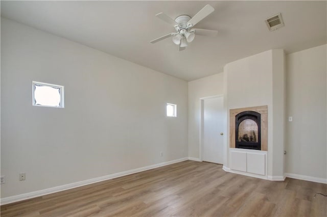 unfurnished living room with light wood-type flooring and ceiling fan