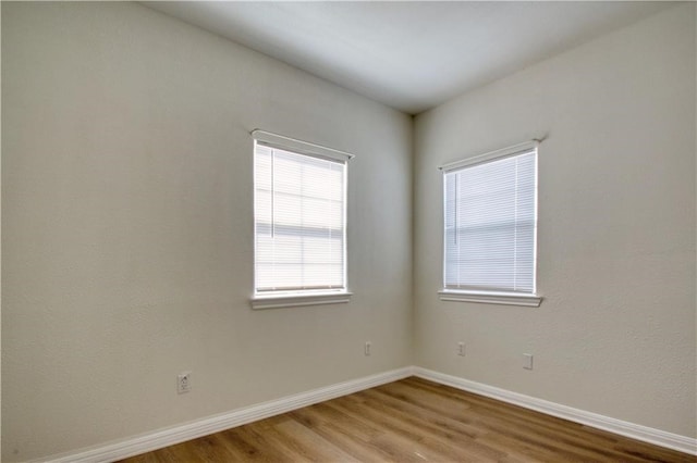 spare room with hardwood / wood-style flooring