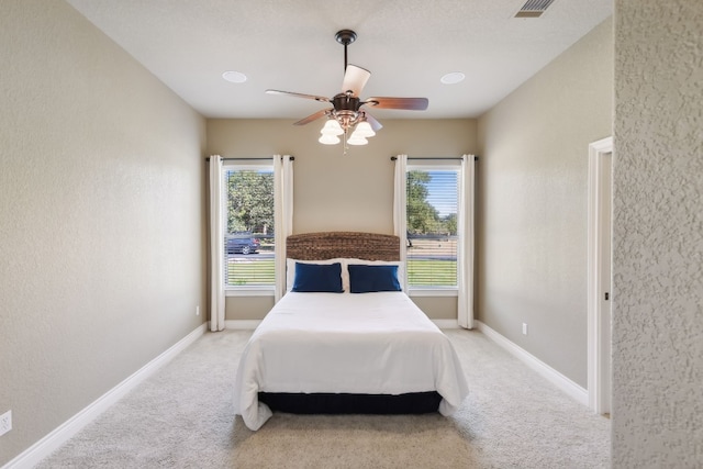 bedroom featuring ceiling fan and light colored carpet