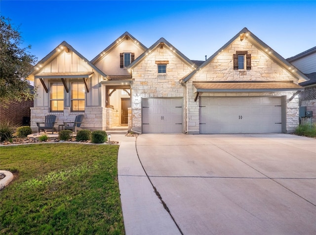 craftsman-style house featuring a garage and a yard