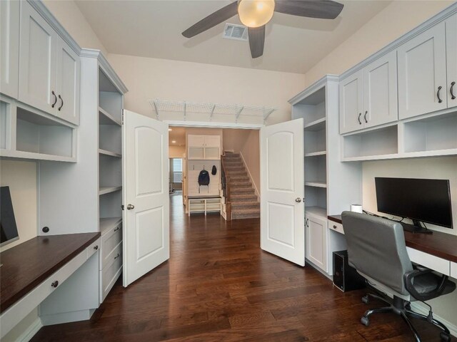 office space with built in desk, ceiling fan, and dark hardwood / wood-style floors