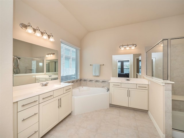 bathroom featuring plus walk in shower, vaulted ceiling, vanity, and tile patterned floors