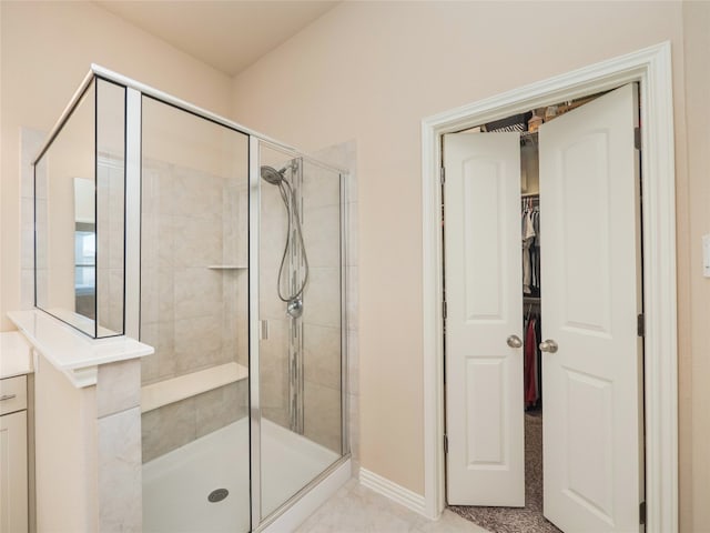 bathroom with vanity and a shower with door