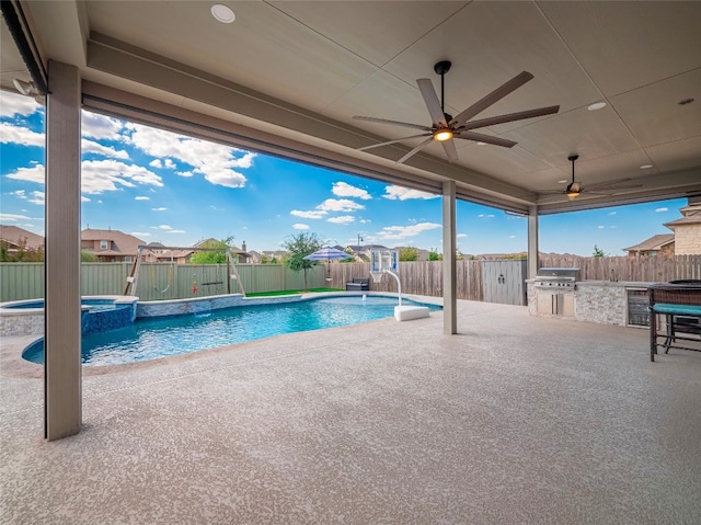 view of swimming pool with exterior kitchen, a patio, pool water feature, area for grilling, and ceiling fan