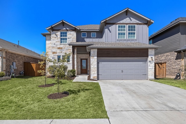 view of front of property with a front yard and a garage