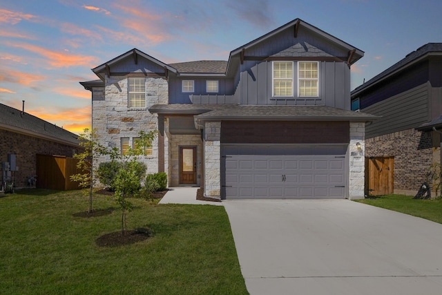 view of front of home with a yard and a garage