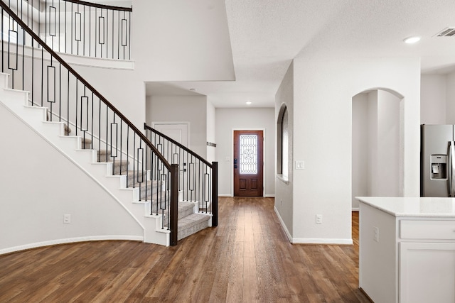 entryway with a textured ceiling and dark hardwood / wood-style floors