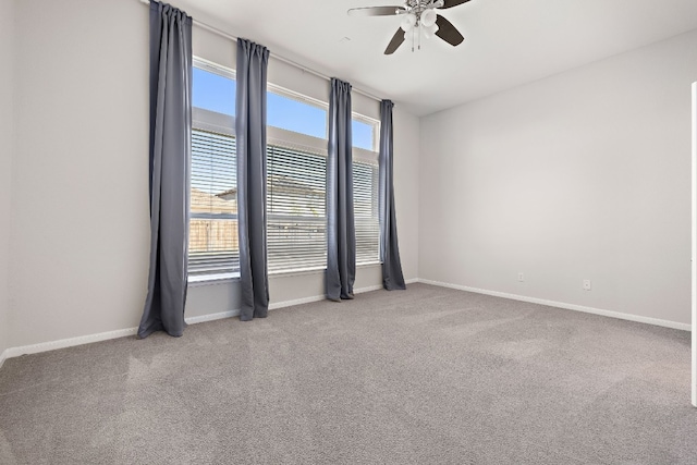 carpeted spare room featuring ceiling fan