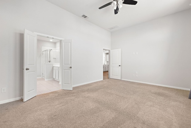 unfurnished bedroom with light carpet, ensuite bath, and ceiling fan