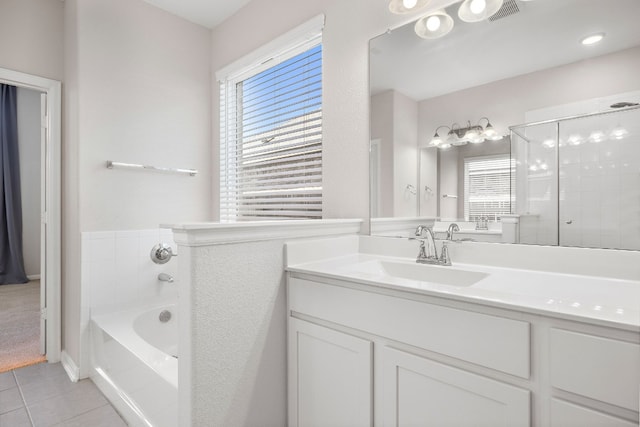 bathroom with shower with separate bathtub, vanity, tile patterned floors, and a wealth of natural light