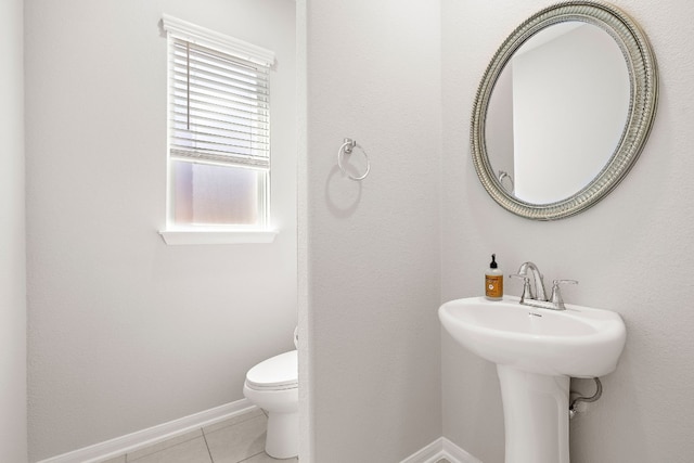 bathroom featuring tile patterned flooring, sink, and toilet