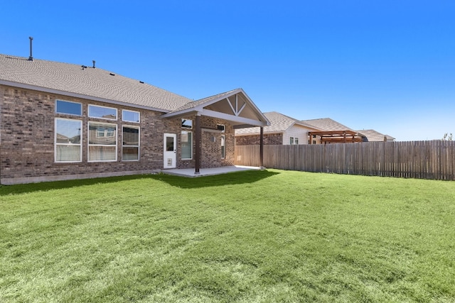 back of property featuring a lawn and a patio