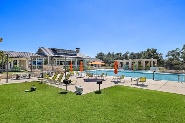 view of swimming pool with a lawn and a patio area