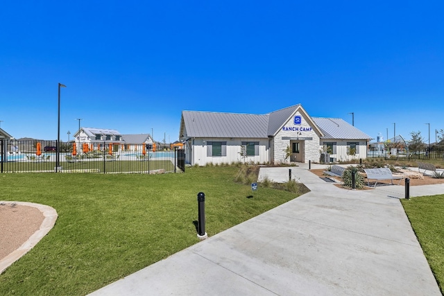 exterior space featuring a front yard and a swimming pool