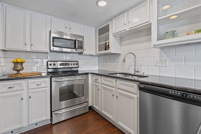 kitchen featuring backsplash, sink, white cabinetry, and stainless steel appliances