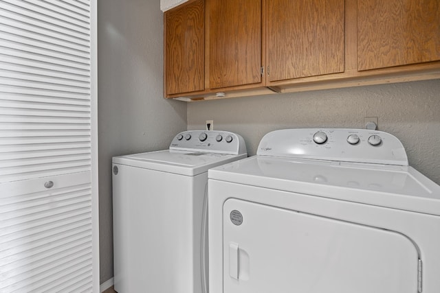 laundry area featuring cabinets and washer and clothes dryer