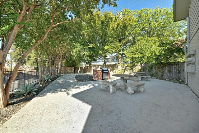 view of patio featuring a fenced backyard and a grill