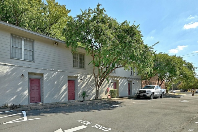 view of property featuring uncovered parking