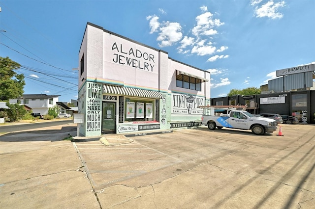 view of building exterior with uncovered parking