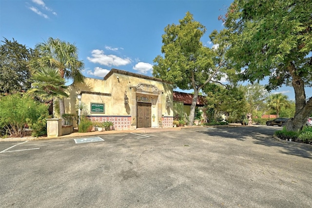 view of front of property with uncovered parking and stucco siding