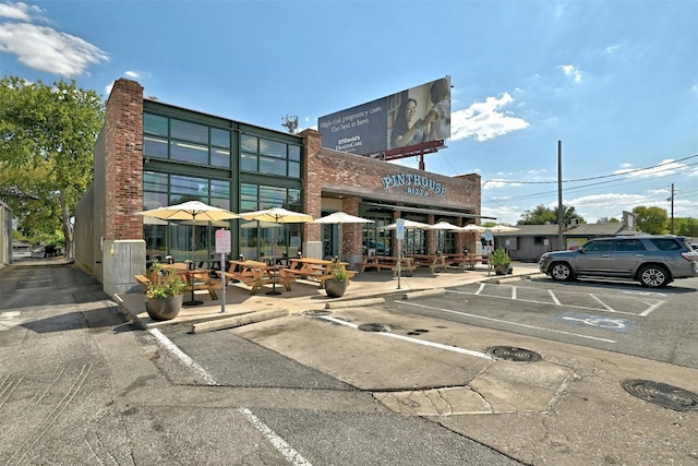 view of building exterior featuring uncovered parking