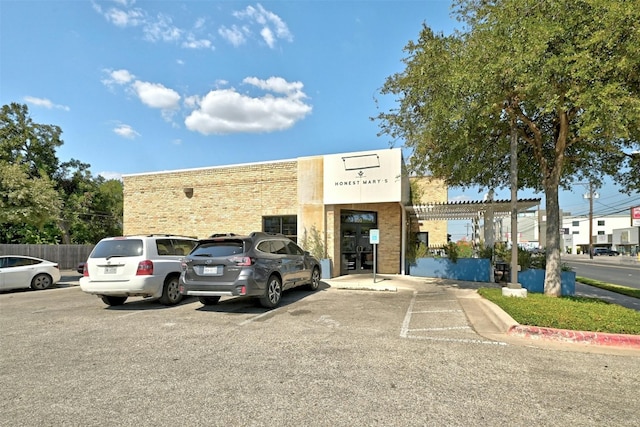 view of building exterior with uncovered parking