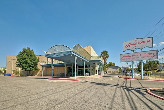 exterior space featuring curbs and street lighting