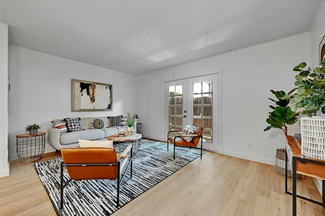 living area featuring light wood-style floors, french doors, and baseboards