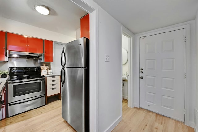 kitchen with red cabinets, stainless steel appliances, light countertops, light wood-type flooring, and under cabinet range hood