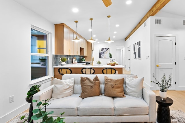 living room featuring vaulted ceiling with beams and wood-type flooring