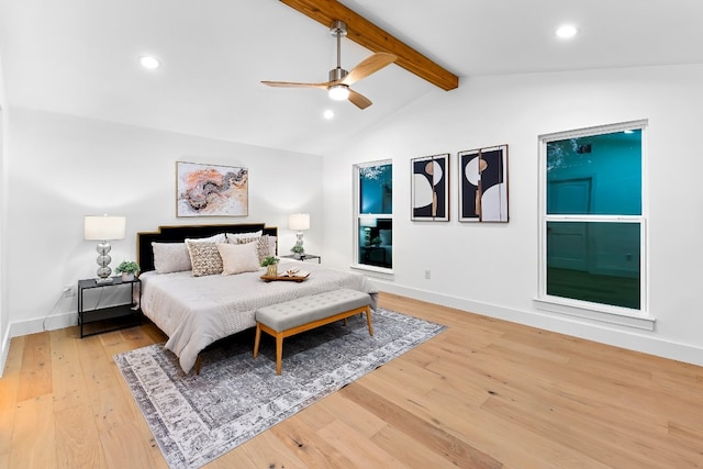 bedroom featuring ceiling fan, vaulted ceiling with beams, and light hardwood / wood-style floors