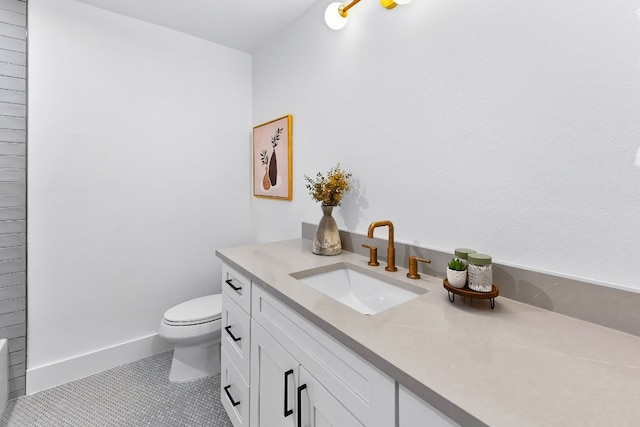 bathroom with vanity, toilet, and tile patterned floors