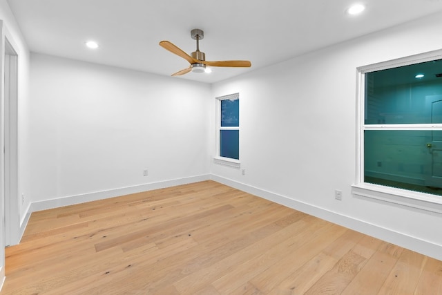 spare room featuring light hardwood / wood-style flooring and ceiling fan