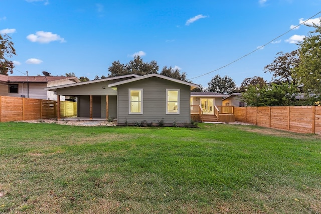 back of property featuring a lawn