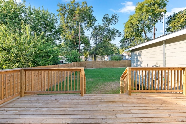 wooden deck featuring a lawn