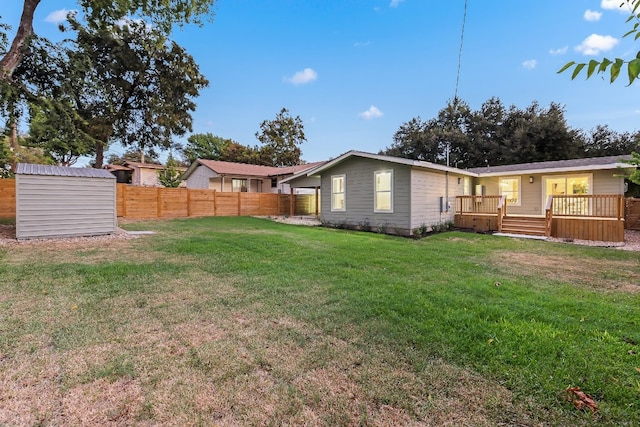 view of yard featuring a deck and a shed