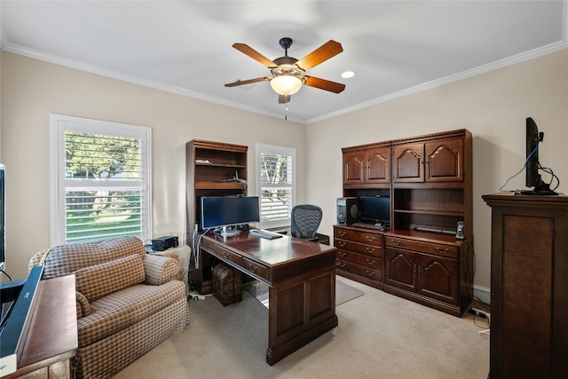 home office with a ceiling fan, ornamental molding, a wealth of natural light, and light colored carpet