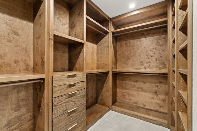 spacious closet with light tile patterned floors