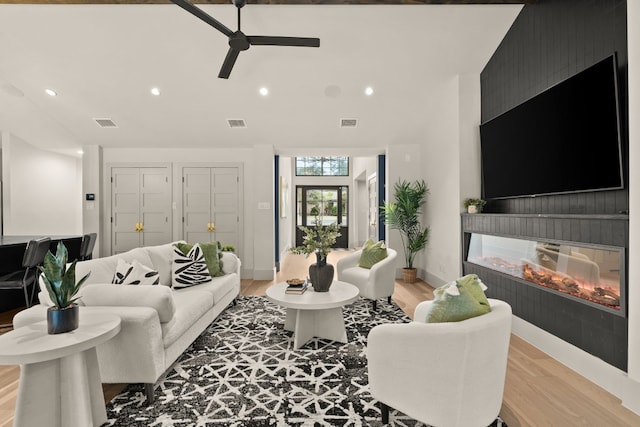 3801 Sierra Dr, Georgetown, TX 78628 - living area featuring a glass covered fireplace, recessed lighting, light wood-style flooring, a ceiling fan, and baseboards