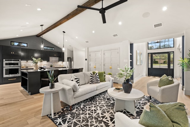 living room featuring beam ceiling, ceiling fan, high vaulted ceiling, and light hardwood / wood-style floors