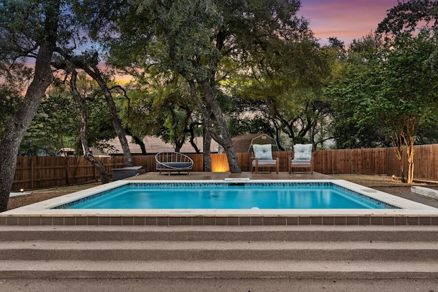 view of pool at dusk